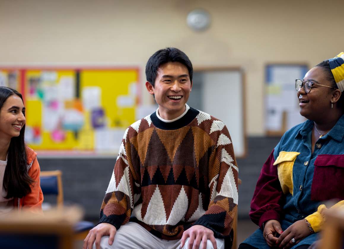 An image on a web page about Kids Help Phone’s mental health website of a group of people smiling in a room