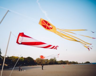 Three kites flying above a beach