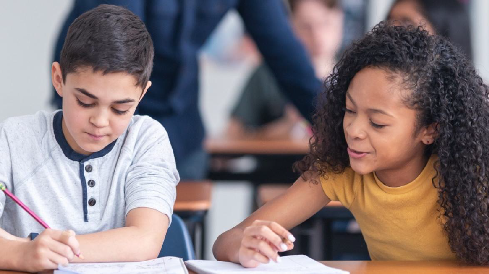 Two young people going back to school working at a desk