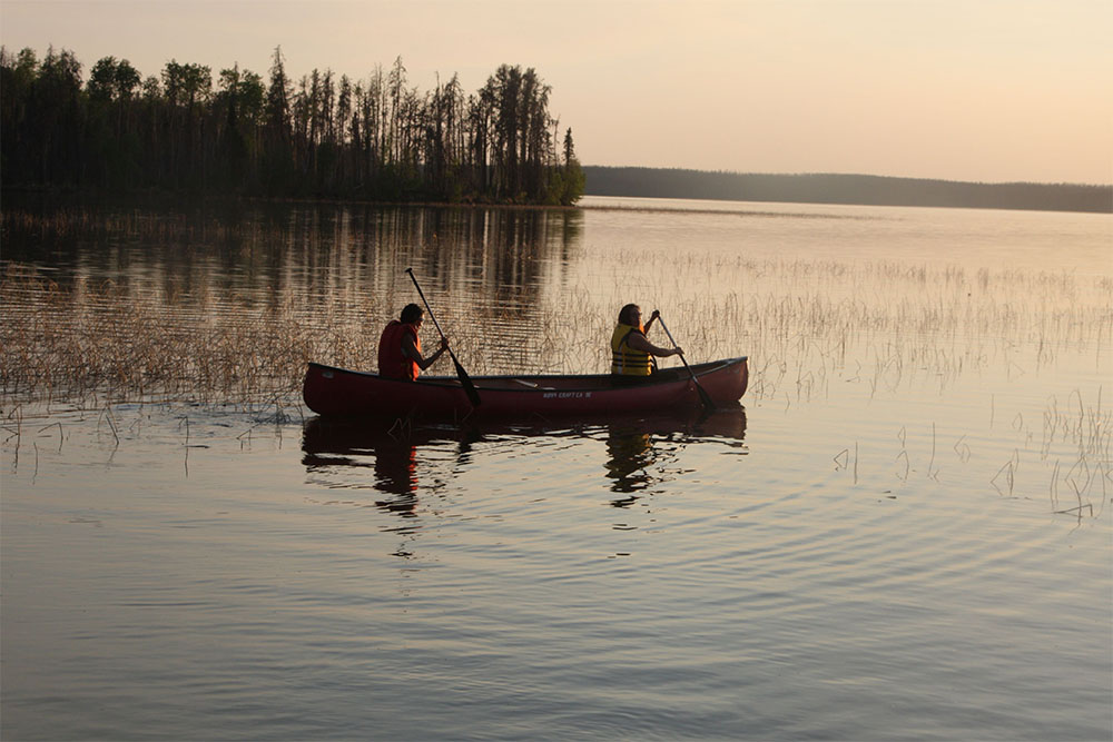 Two people in a canoe on a lake